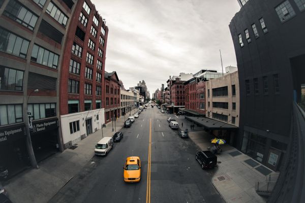 Taxi waiting at a curb in a city