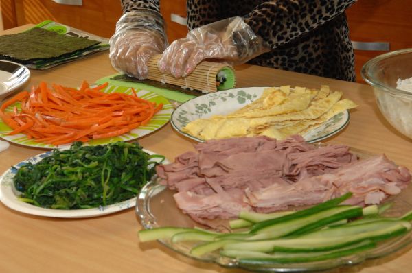Home cook preparing vegetable side dishes in a Korean kitchen