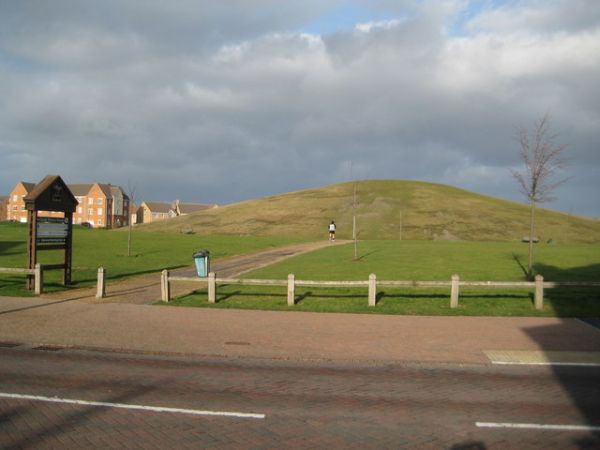 Grass-covered ancient burial mounds in a historic park