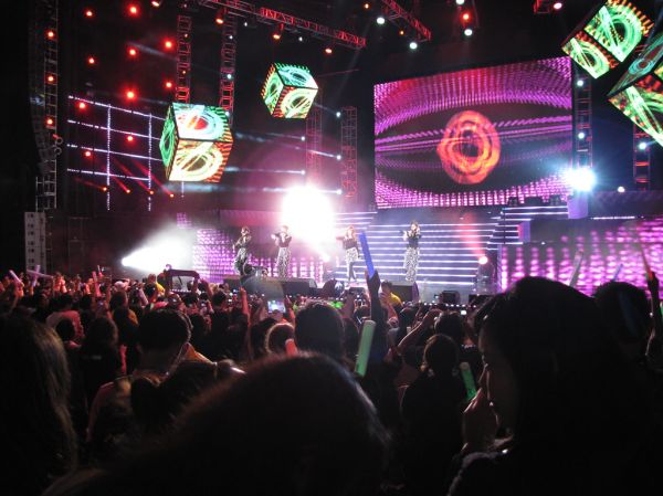 Bright stage lights at a K-pop style concert
