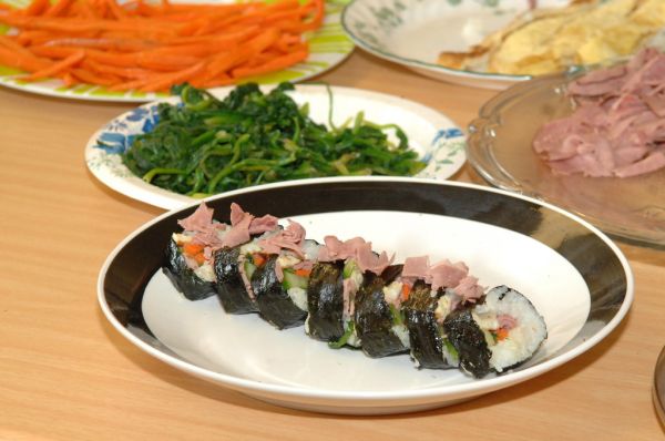 Diner using chopsticks to pick up banchan at a Korean restaurant