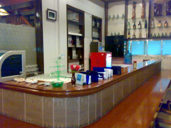 Small Korean restaurant with tables and menu boards